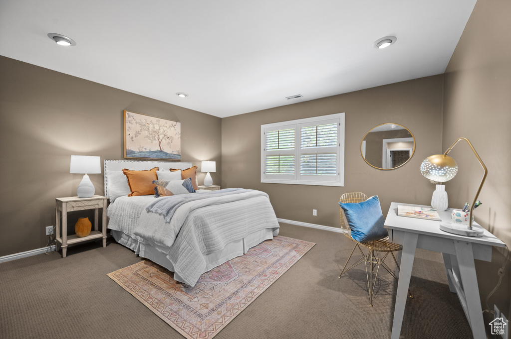 Carpeted bedroom featuring baseboards