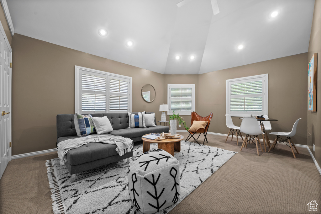 Carpeted living room featuring recessed lighting, baseboards, and vaulted ceiling