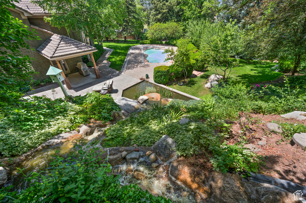 View of yard featuring a gazebo, a patio, and an outdoor pool