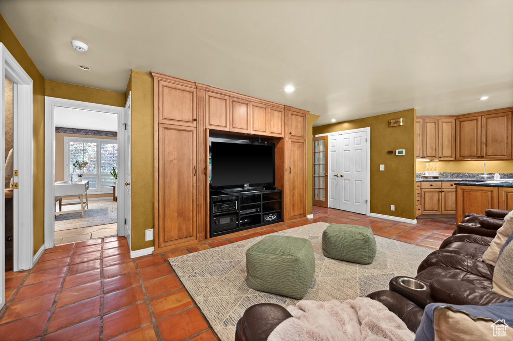Living area featuring light tile patterned floors, recessed lighting, and baseboards