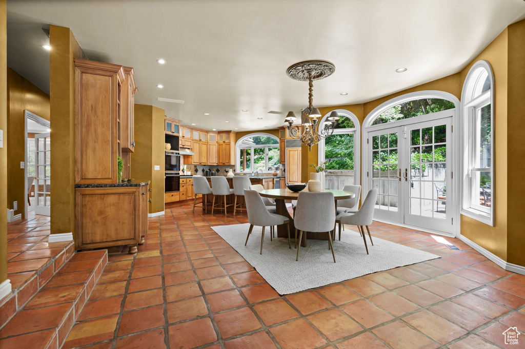 Dining room with recessed lighting, a chandelier, and baseboards