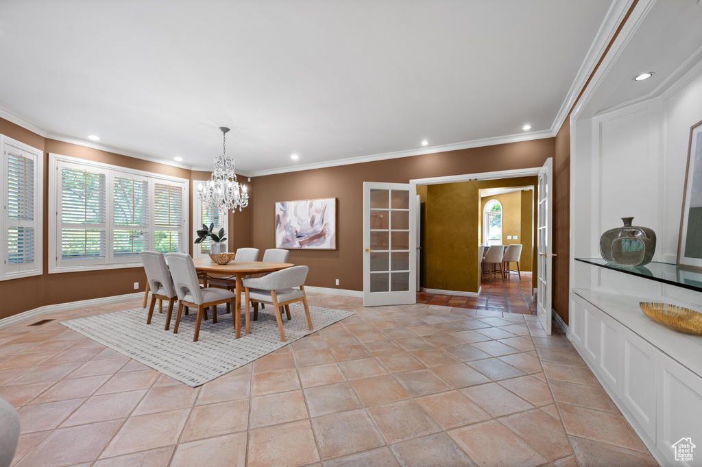 Dining area featuring recessed lighting, healthy amount of natural light, a chandelier, ornamental molding, and baseboards