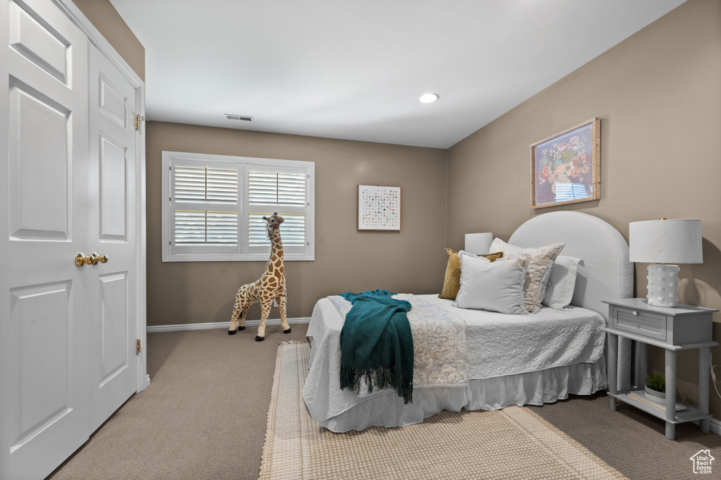 Carpeted bedroom with baseboards
