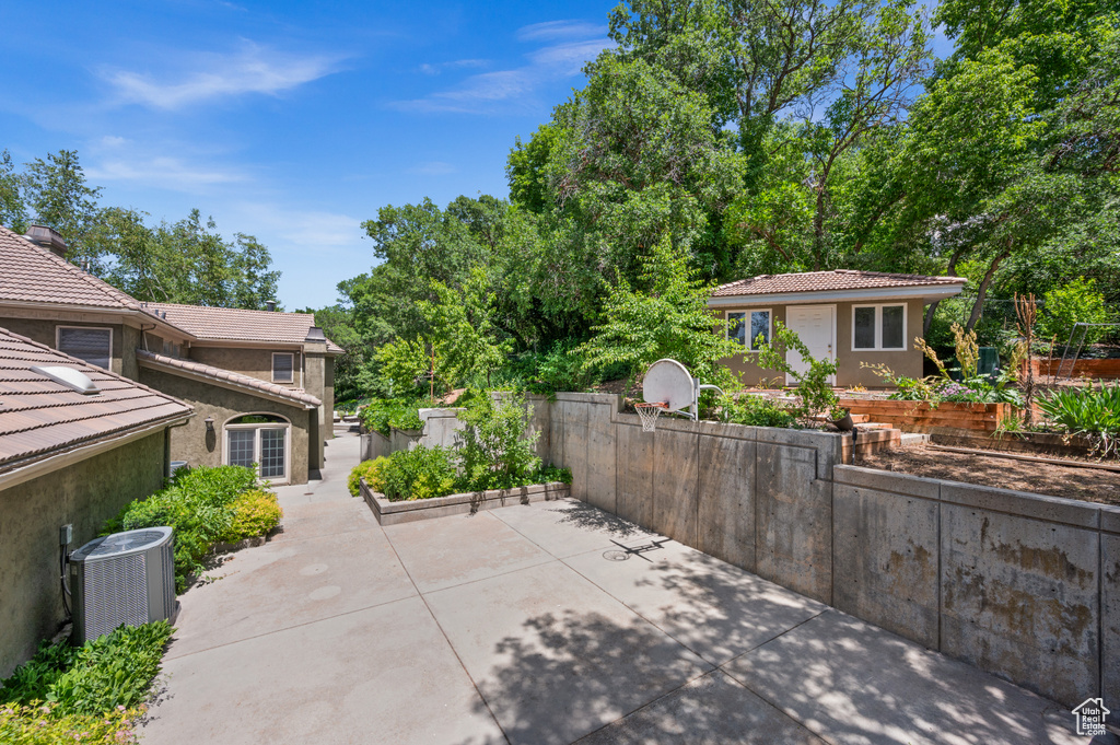 View of patio featuring central AC unit and an outdoor structure