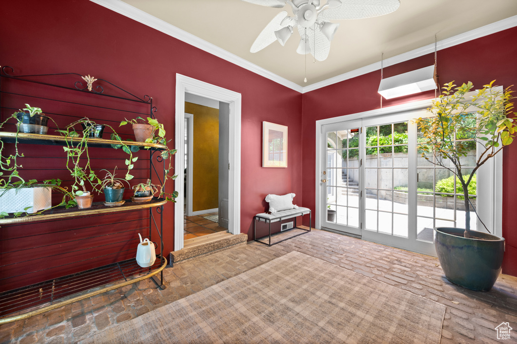 Entrance foyer featuring a ceiling fan and crown molding