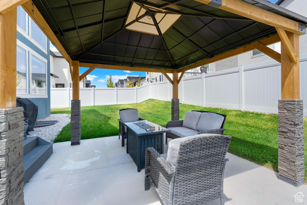 View of patio with a gazebo and an outdoor living space