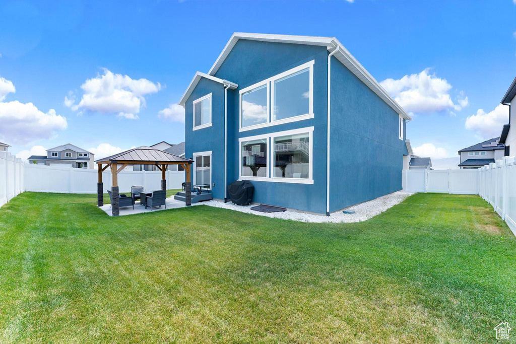 Rear view of house with a gazebo, a patio, an outdoor hangout area, and stucco siding