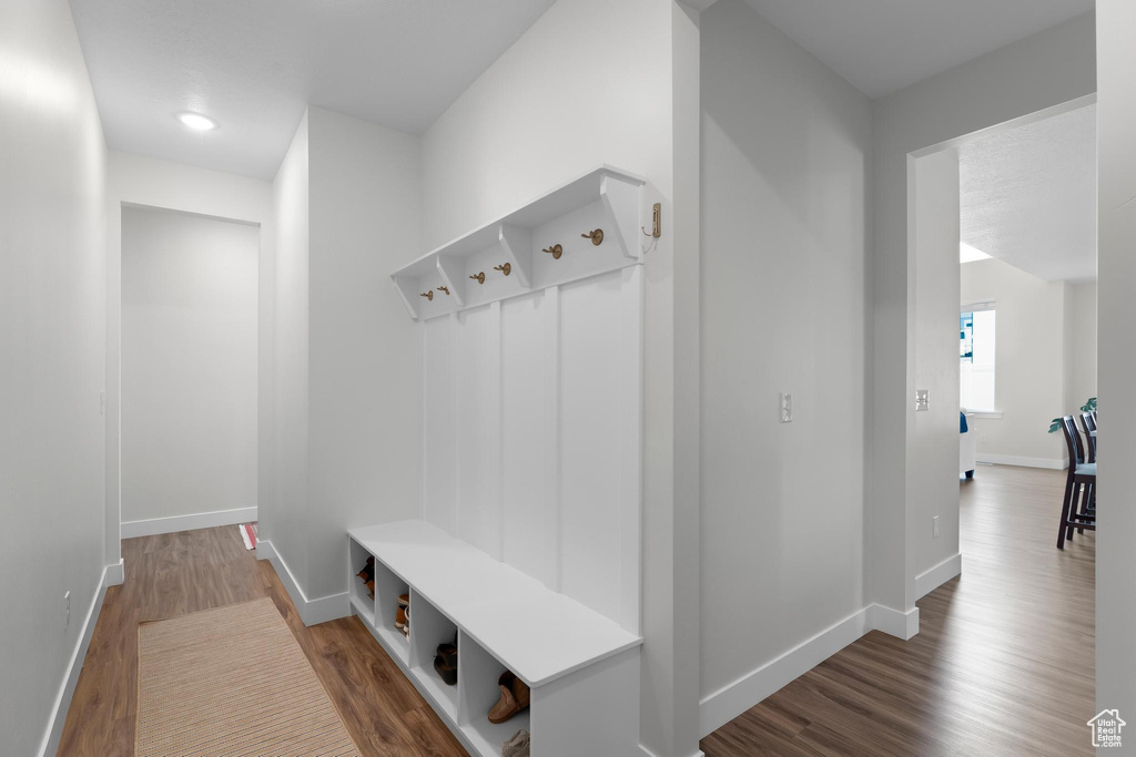 Mudroom with wood finished floors and baseboards