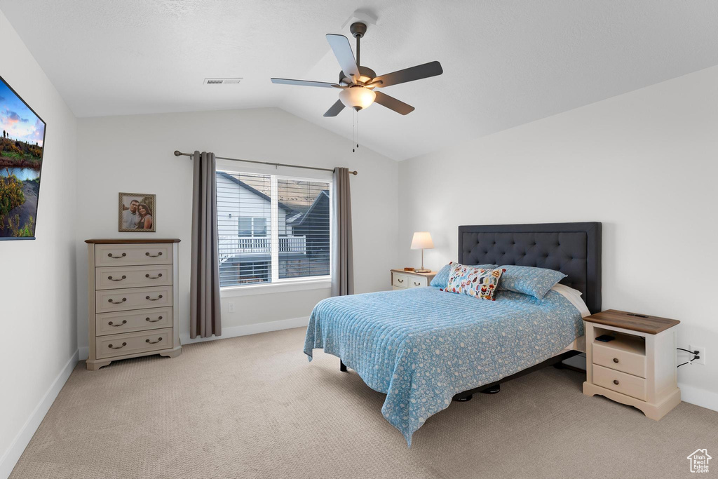 Bedroom featuring carpet flooring, baseboards, lofted ceiling, and a ceiling fan