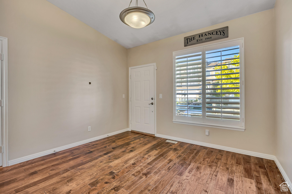 Entryway with wood finished floors and baseboards