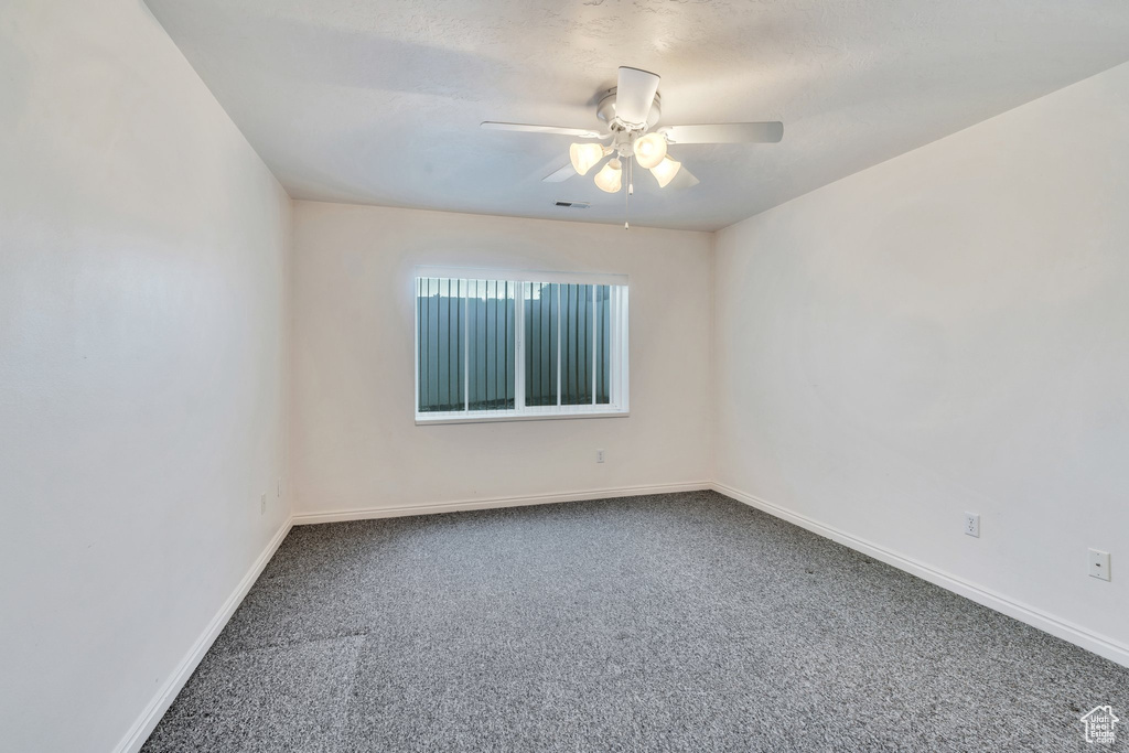 Spare room with carpet floors and ceiling fan