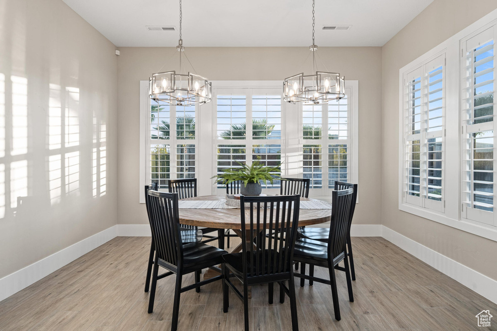 Dining space with a chandelier and light wood-style floors