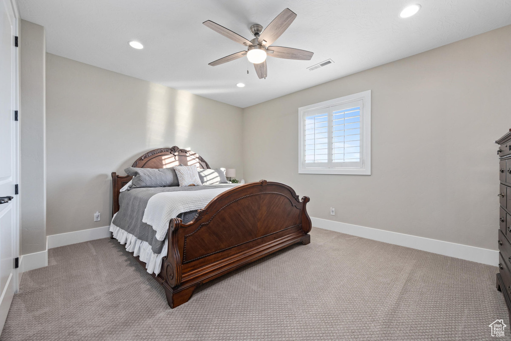 Carpeted bedroom featuring recessed lighting and a ceiling fan