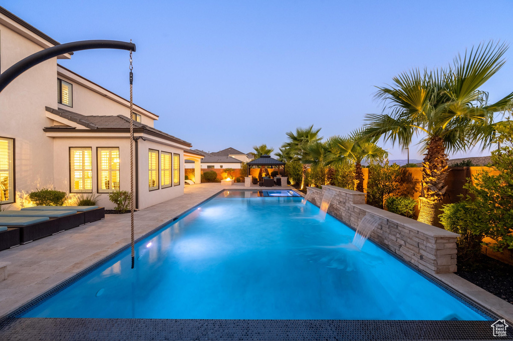View of swimming pool with a gazebo and a patio