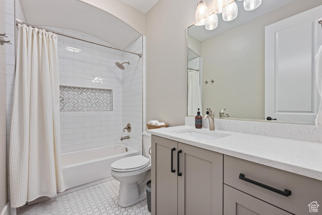 Full bath featuring vanity and shower / bathtub combination with curtain