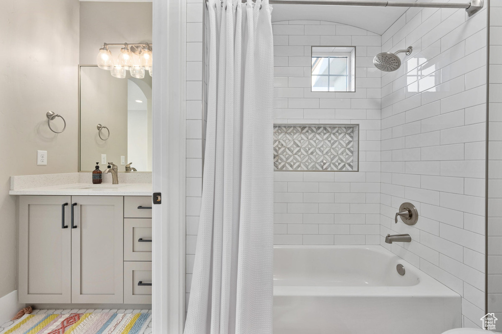 Full bathroom featuring shower / tub combo with curtain and vanity