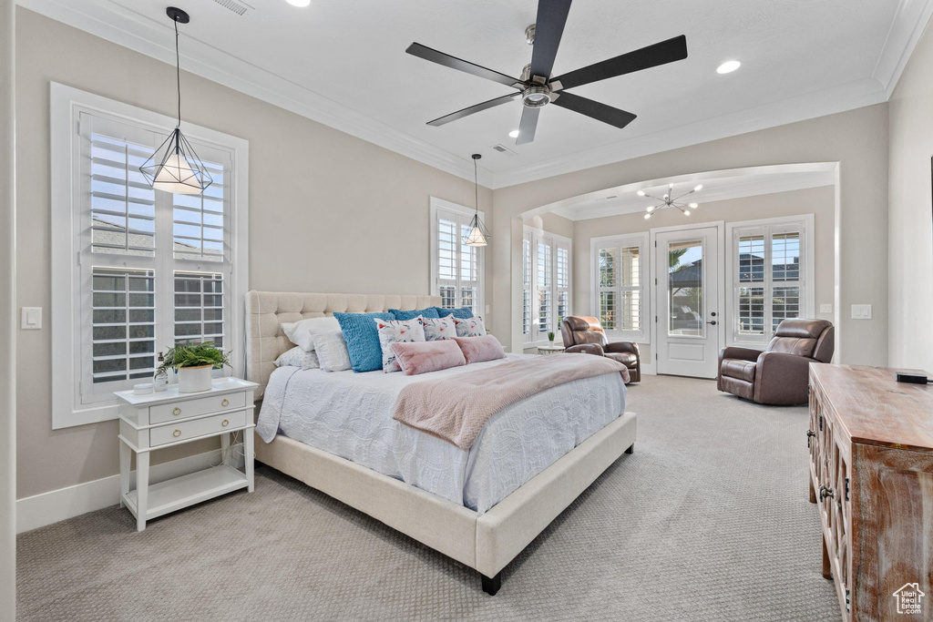 Carpeted bedroom with crown molding, multiple windows, recessed lighting, access to exterior, and a ceiling fan
