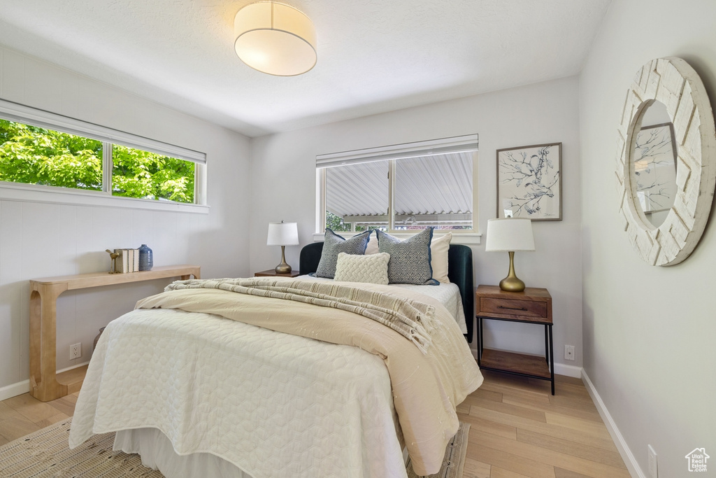 Bedroom featuring light wood-style flooring and baseboards