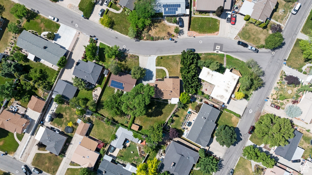 Aerial view of property and surrounding area featuring nearby suburban area