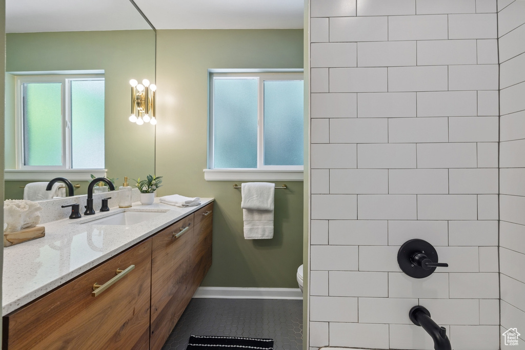 Bathroom featuring vanity, tile patterned floors, and a shower