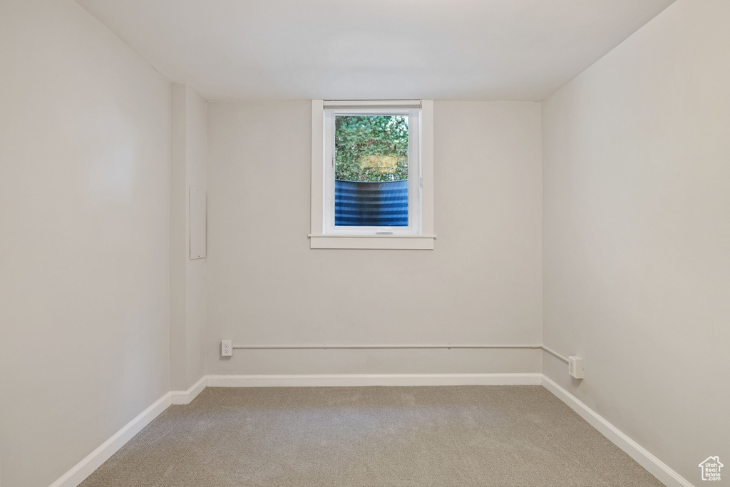 Unfurnished room featuring light colored carpet