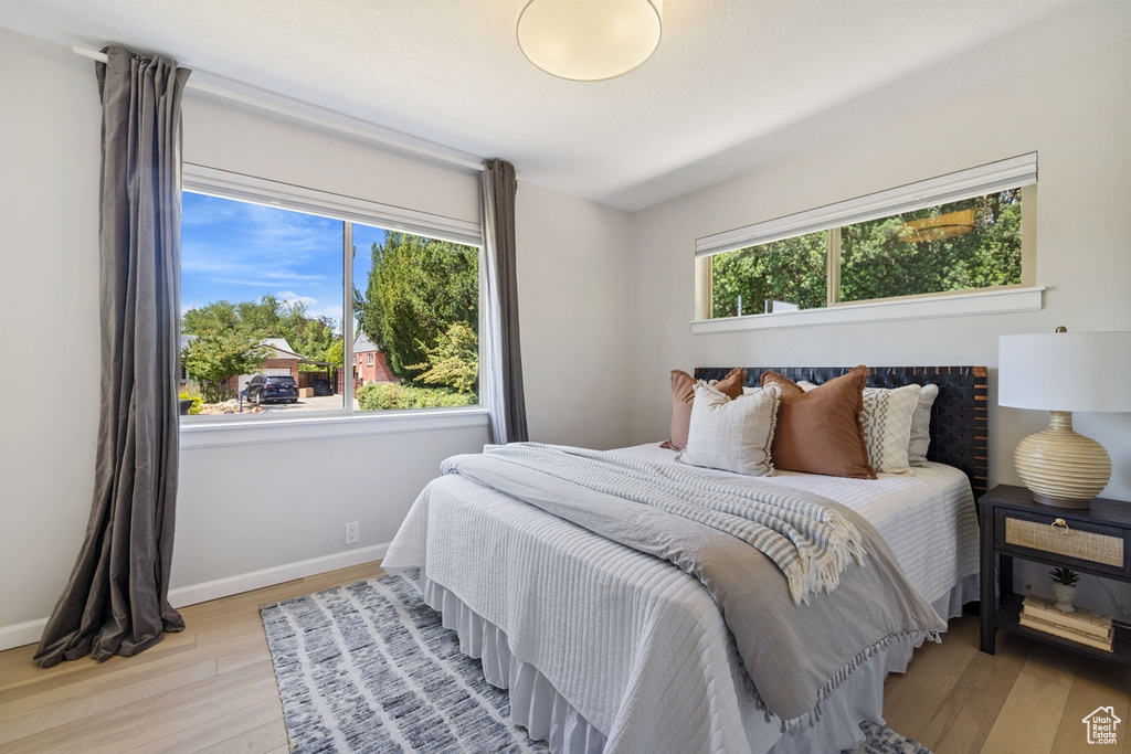 Bedroom with light wood-style floors and baseboards