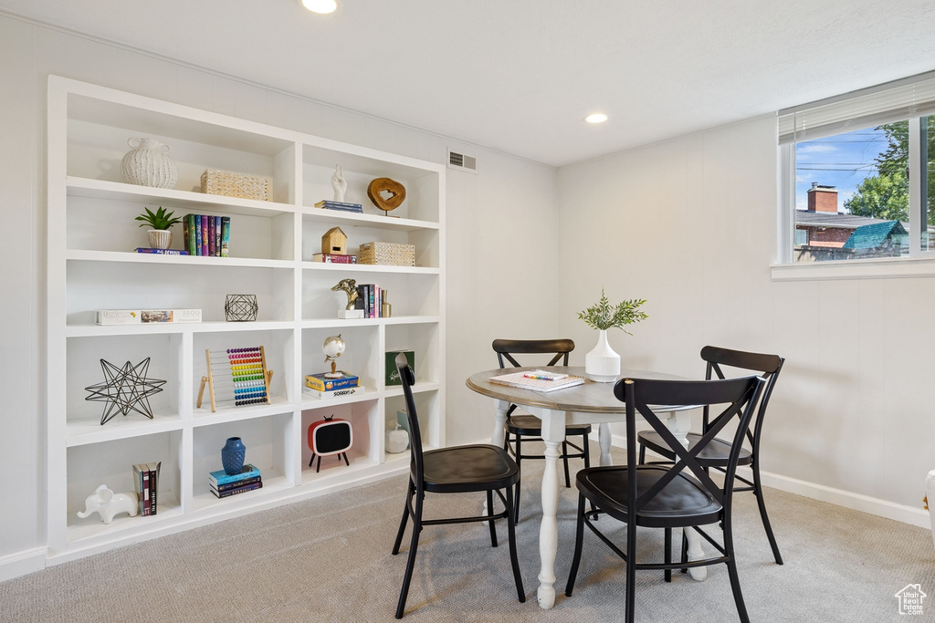 Carpeted dining space with baseboards and recessed lighting