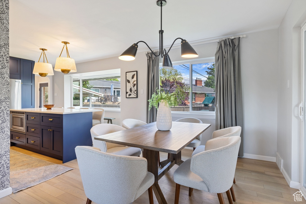 Dining room with light wood-style flooring and baseboards