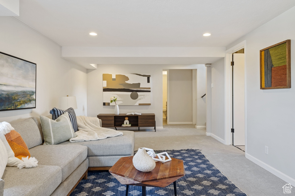 Carpeted living room with recessed lighting