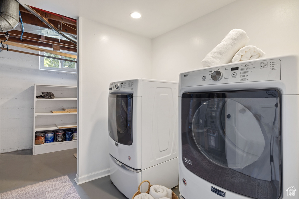 Washroom with washing machine and dryer and recessed lighting