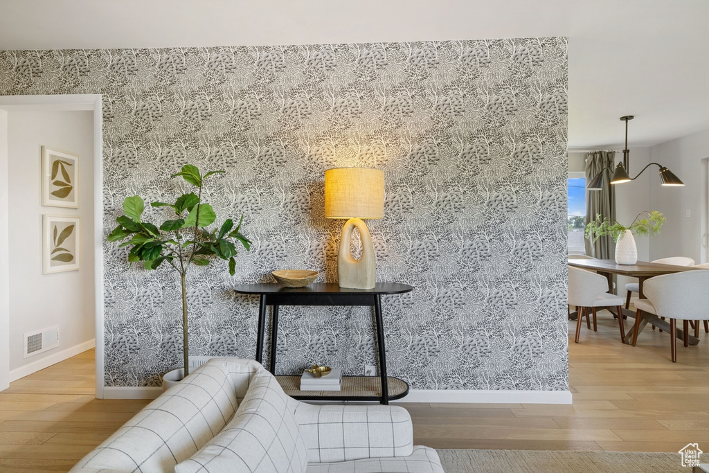 Sitting room featuring wood finished floors and an accent wall