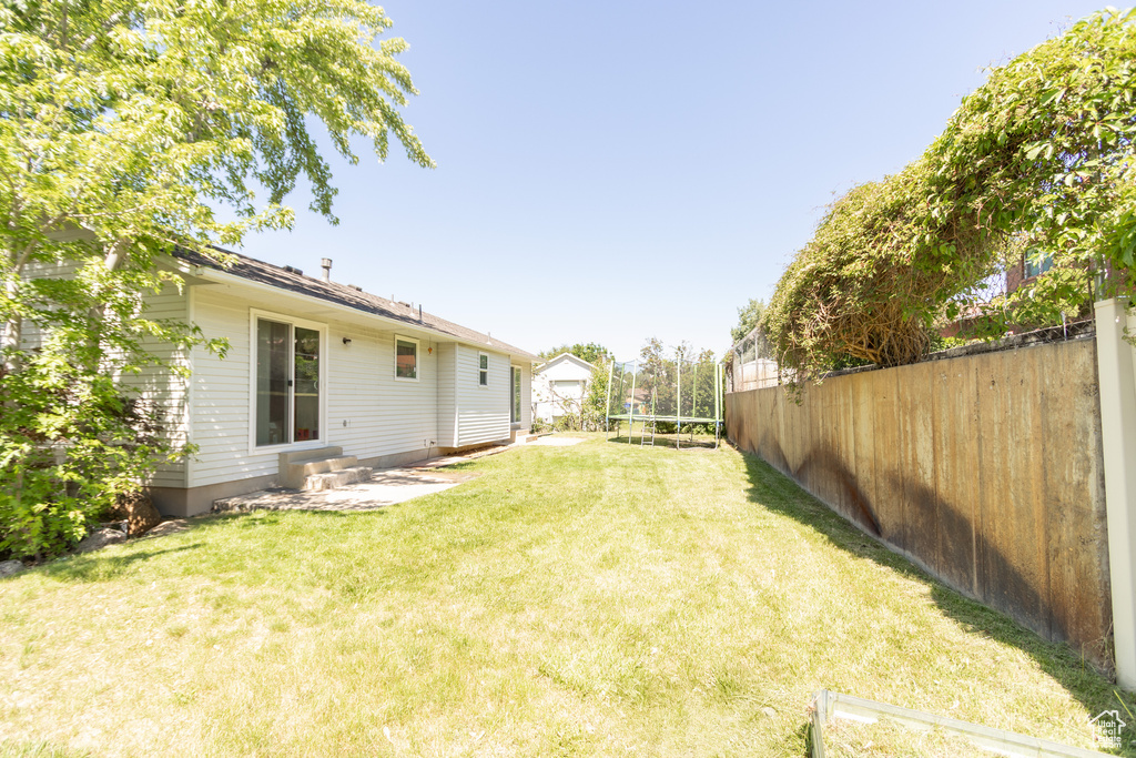 View of yard featuring entry steps and an outbuilding