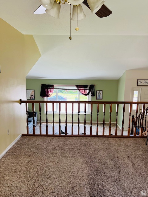 Corridor featuring carpet floors and baseboards