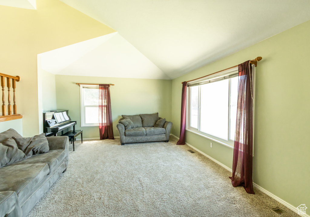 Living room with carpet and lofted ceiling