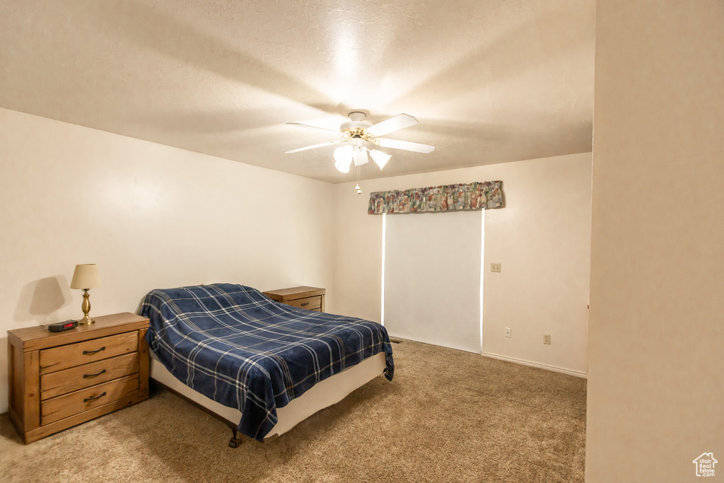 Bedroom featuring light colored carpet and ceiling fan