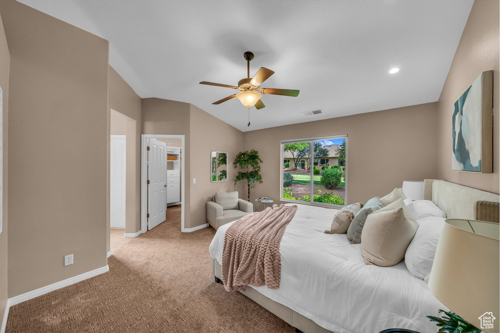 Bedroom featuring light colored carpet, vaulted ceiling, a ceiling fan, and recessed lighting