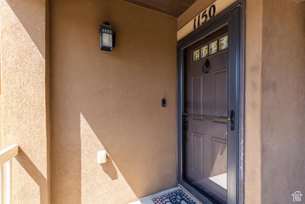 View of exterior entry featuring stucco siding