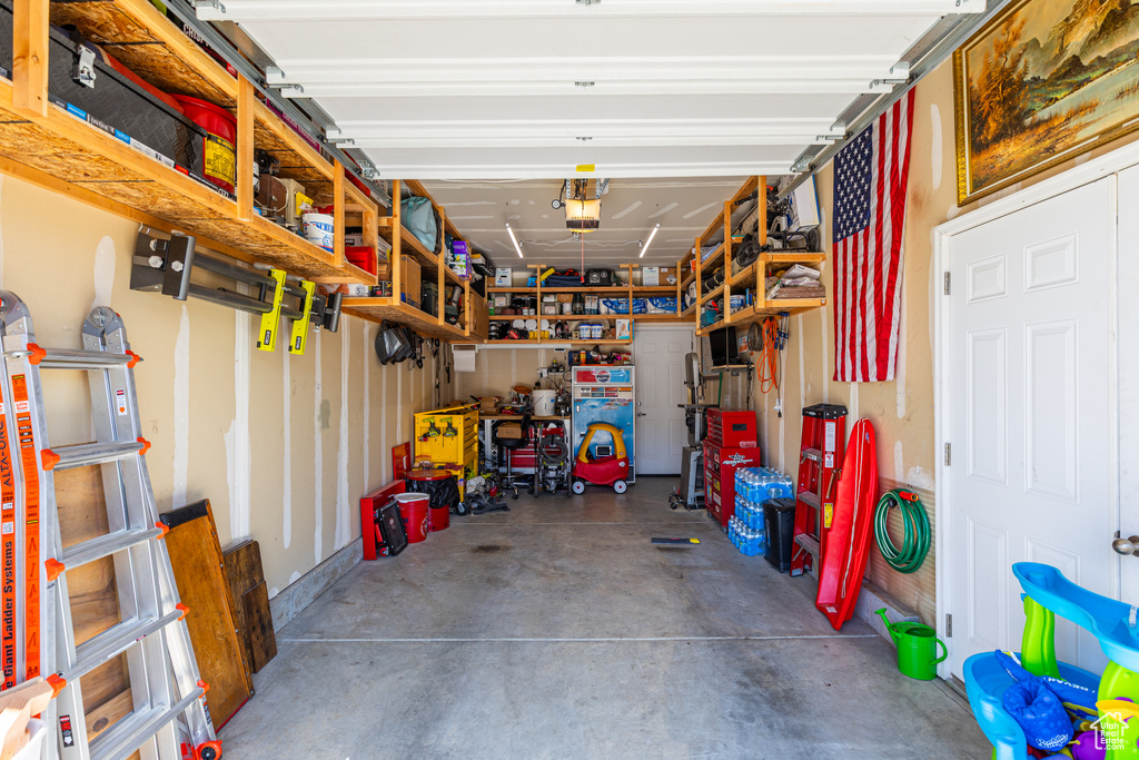 Garage featuring a garage door opener and a workshop area