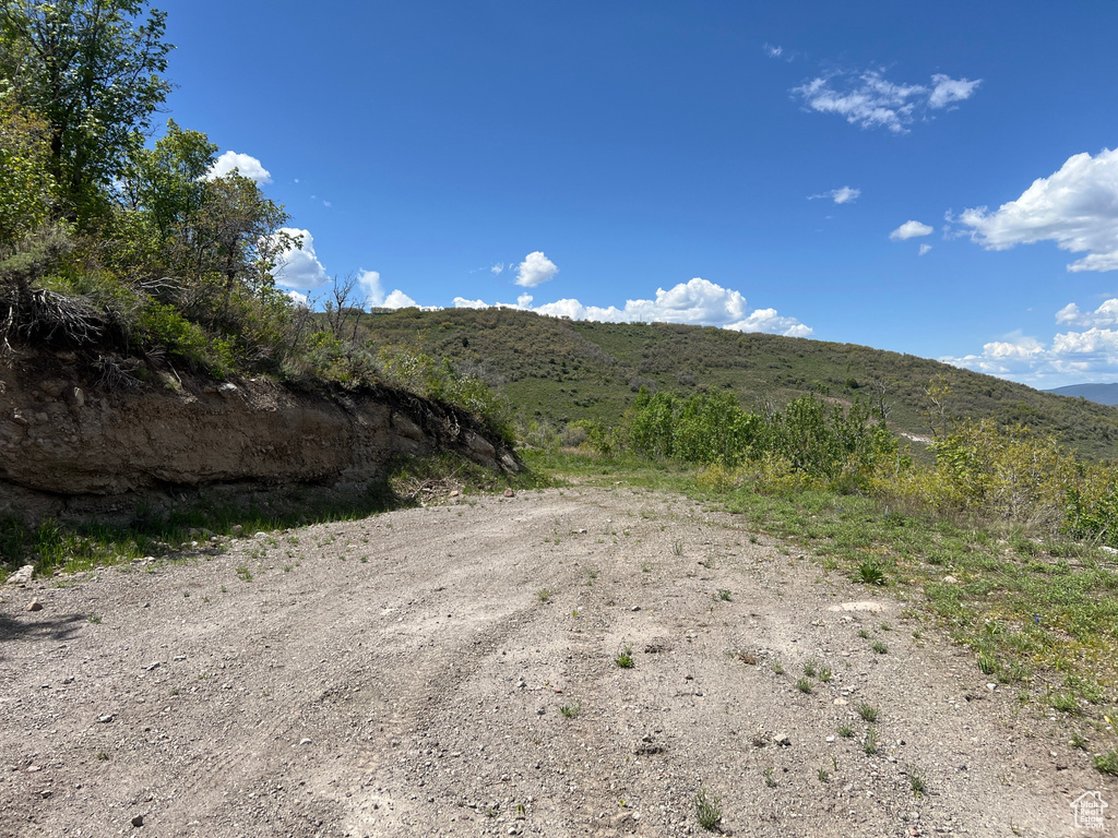 View of dirt / gravel road featuring a mountain view