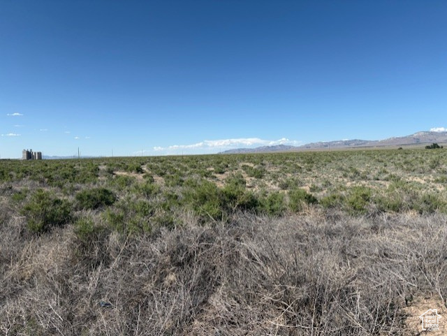 View of mountain backdrop with rural landscape
