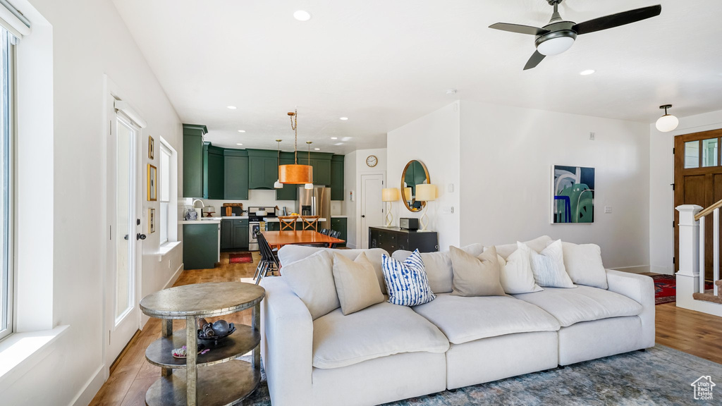 Living room with wood finished floors, recessed lighting, and ceiling fan