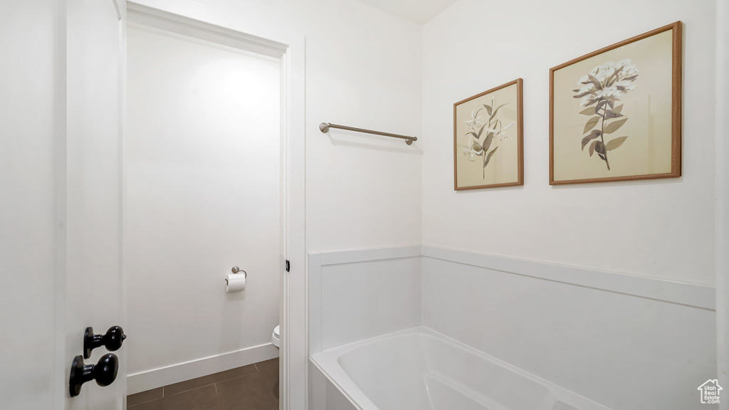 Bathroom featuring a tub to relax in and tile patterned floors