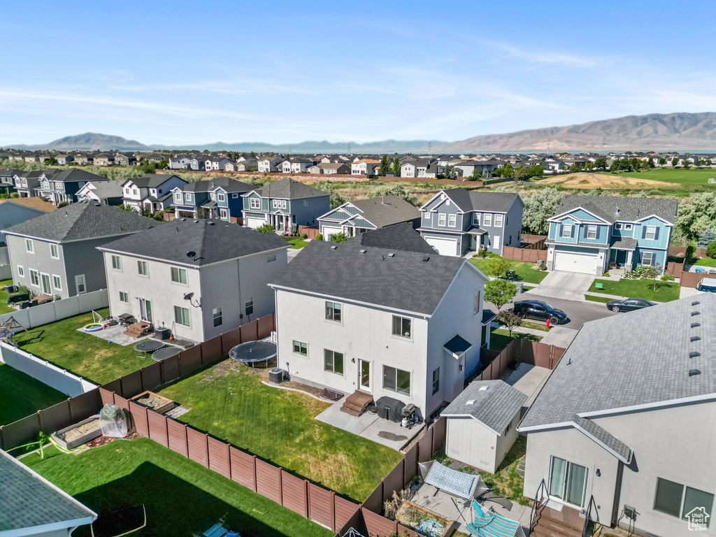Aerial perspective of suburban area with a mountainous background