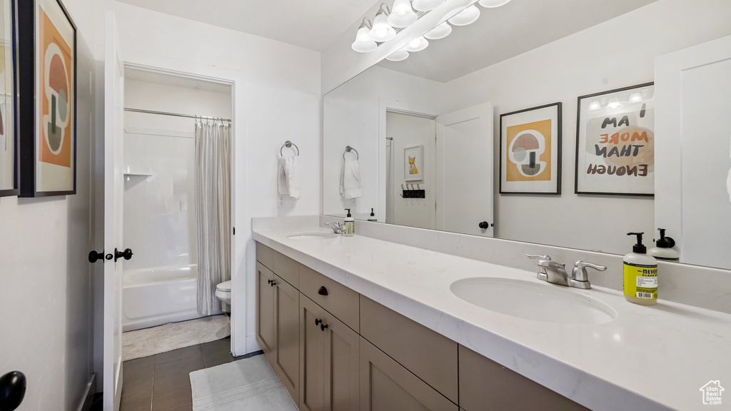 Full bathroom with tile patterned flooring, double vanity, and shower / tub combo