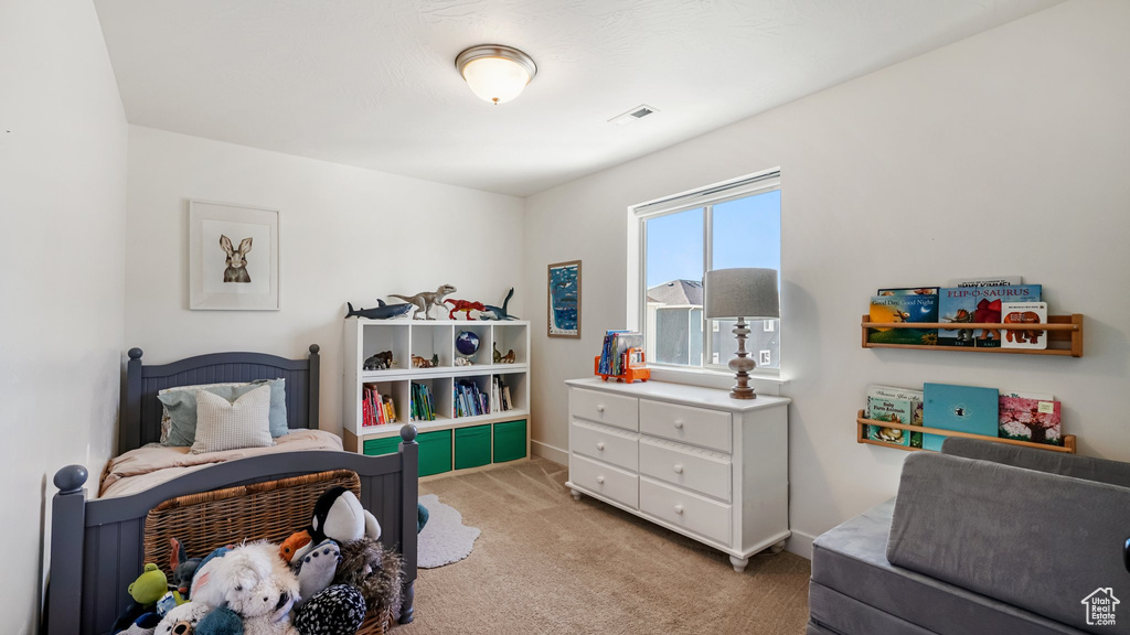 Bedroom featuring light carpet and baseboards