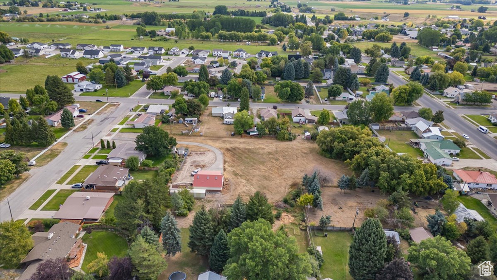 Aerial view of property and surrounding area with nearby suburban area