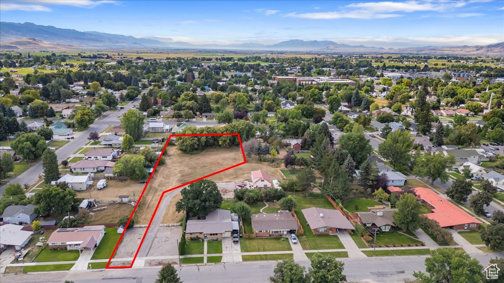 Aerial perspective of suburban area featuring mountains and property boundaries highlighted
