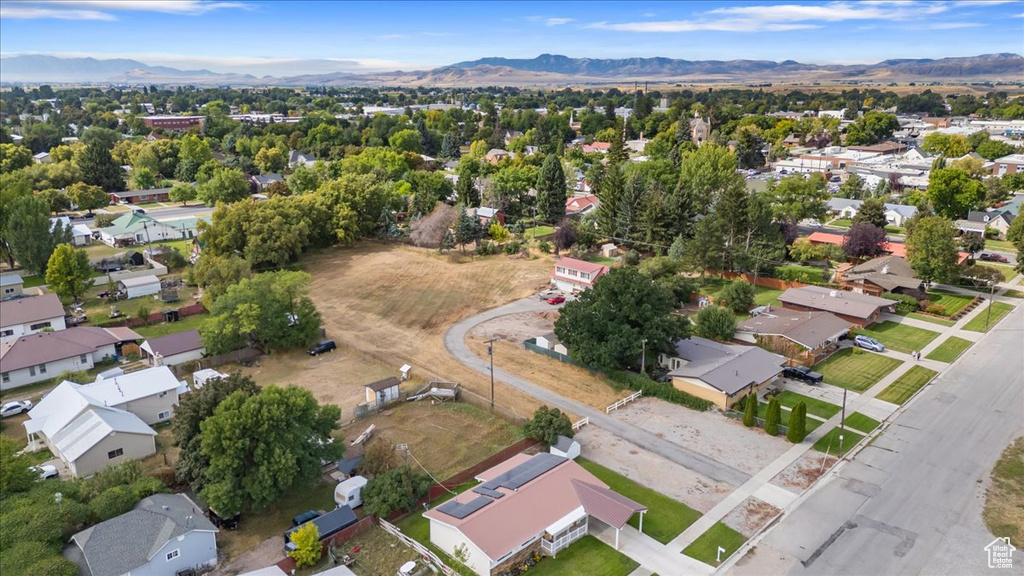 Aerial overview of property's location featuring mountains and nearby suburban area