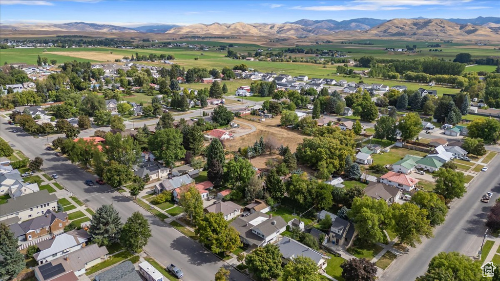 Aerial view of property's location with a mountainous background and nearby suburban area