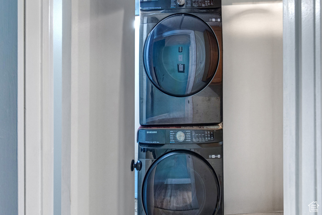 Washroom featuring stacked washer / dryer